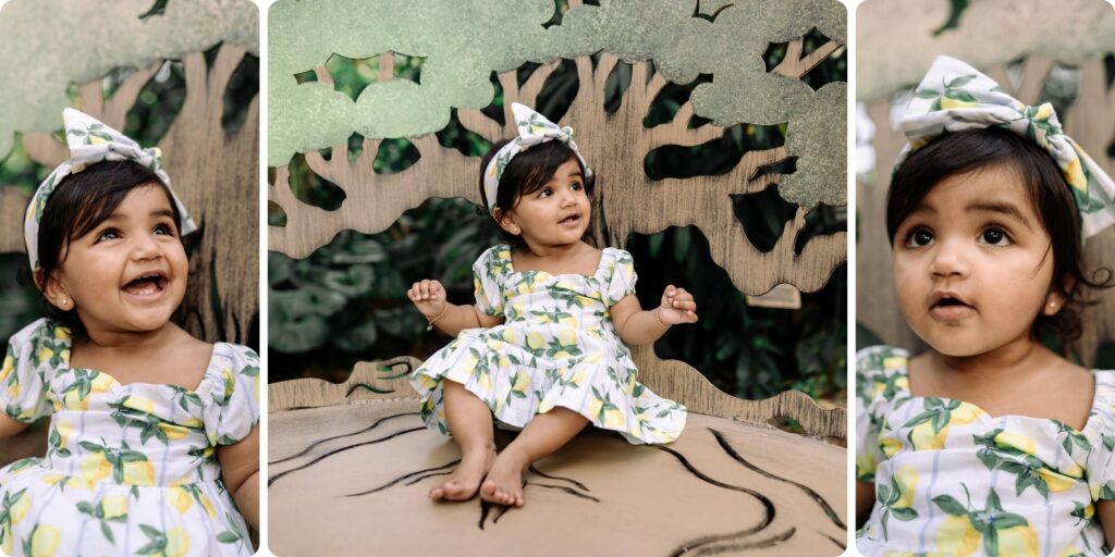 A smiling toddler in a lemon-print dress sits on a whimsical wooden chair during her St. Pete first birthday photography session, with close-up portraits highlighting her bright eyes and playful expressions.