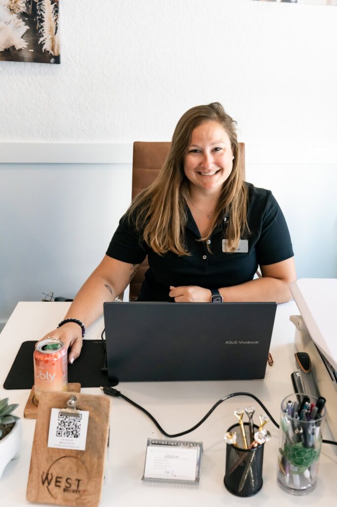 Event manager Heather smiles from her desk