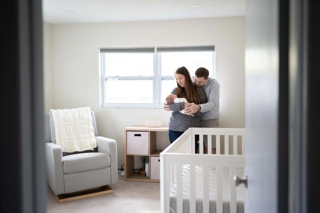 A nursery where new parents are cuddling their daughter