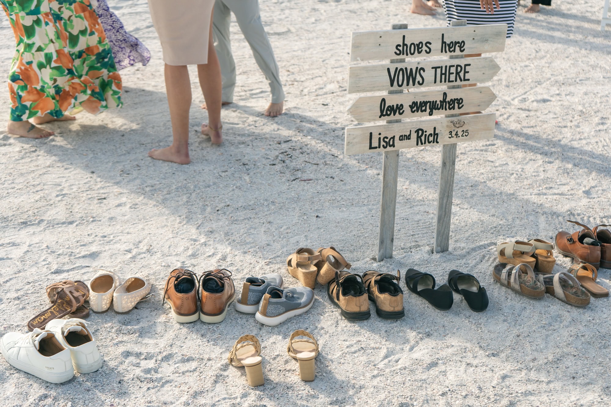 A clever DIY wedding sign inviting guests to leave their shoes and go barefoot on the sand during the celebration