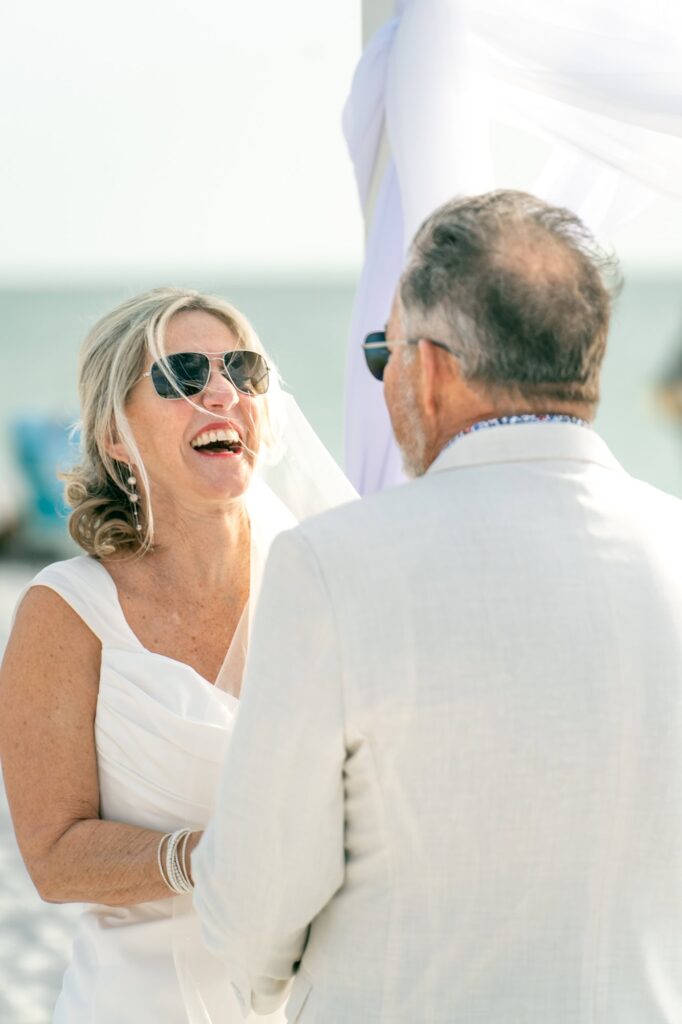 Genuine laughter from the bride as her groom talks to her during the ceremony