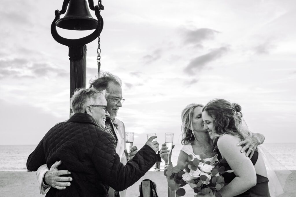 Hugs and kisses to the newly married bride and groom at the bell ringing finale to their celebration