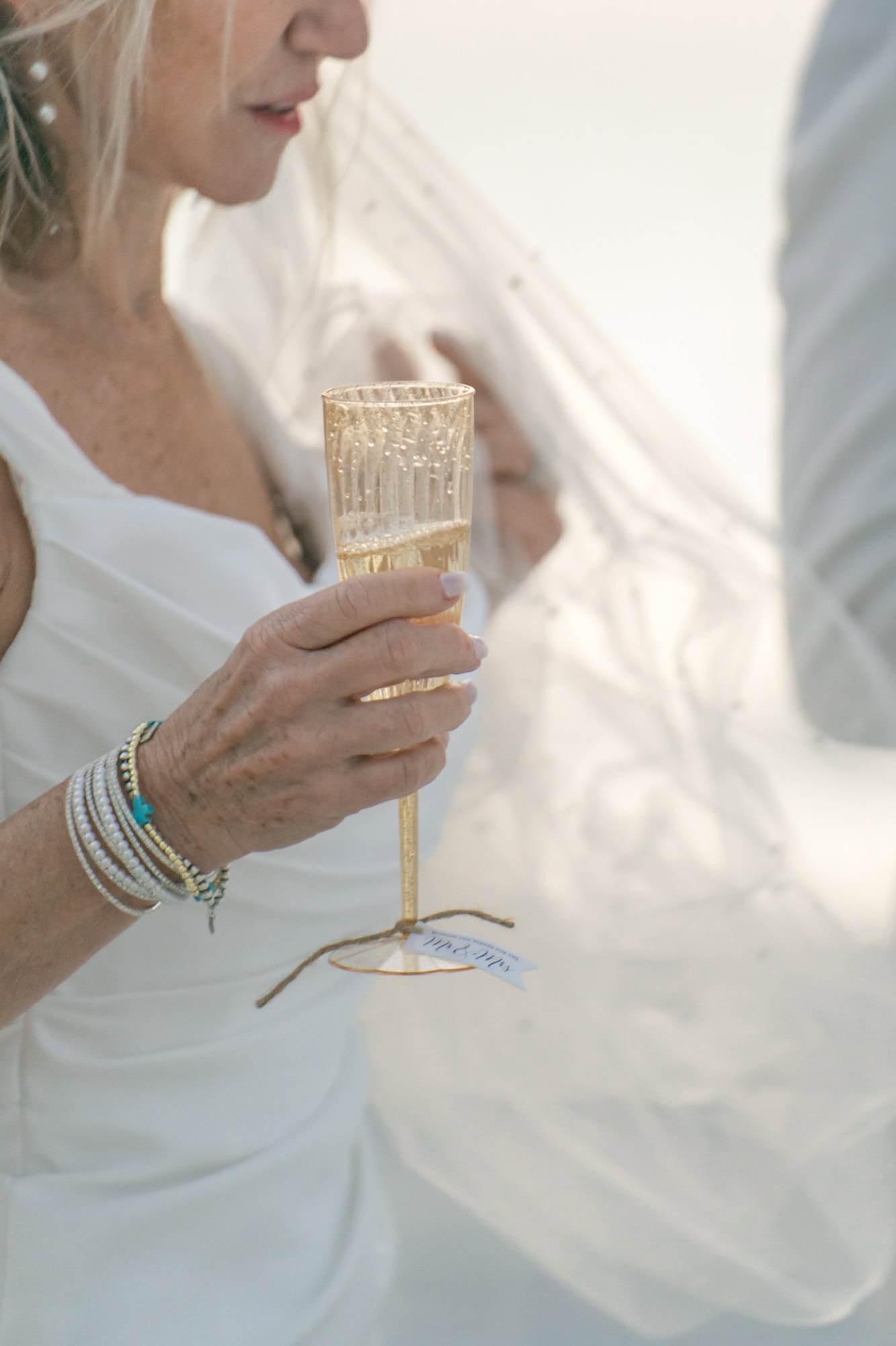 Detail shot of a bride holding her glass of champagne