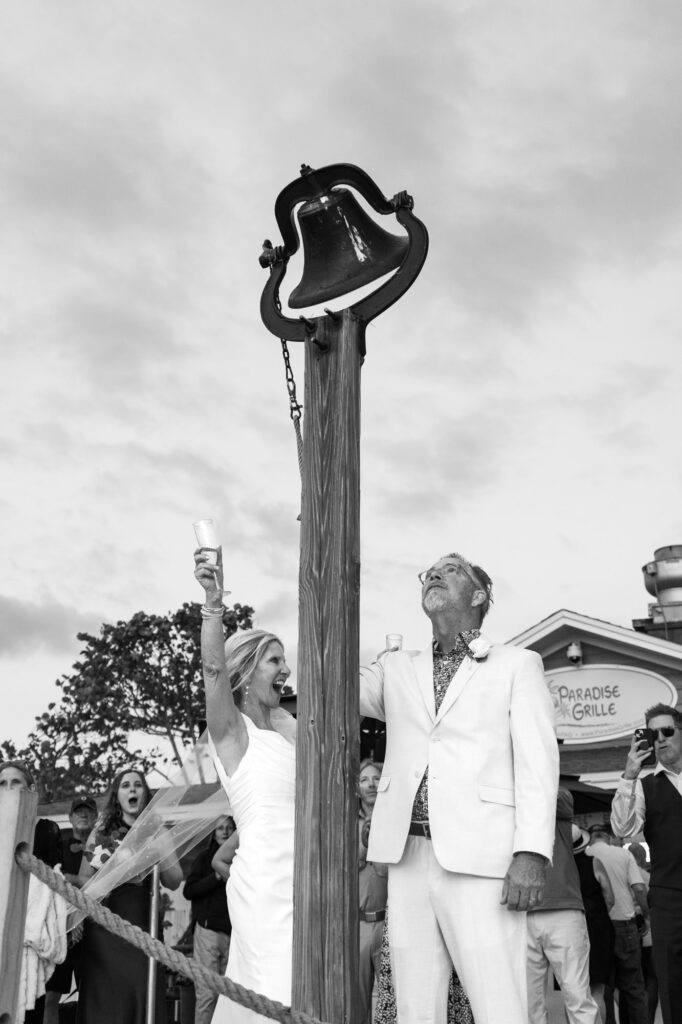 Newlyweds ring the Paradise Grill Bell as the sun sets