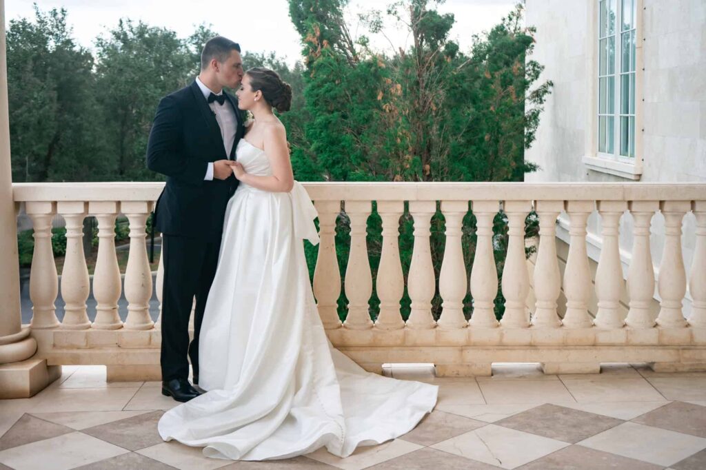 Bride and groom sharing quiet moment together on marble balcony during sunset portraits, photographed by Erin Vestal Photography.
