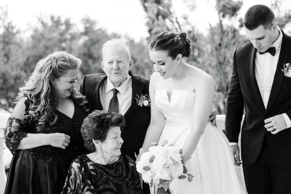 Bride and groom sharing a joyful moment with grandparents and family during Tampa Bay wedding, photographed by Erin Vestal.