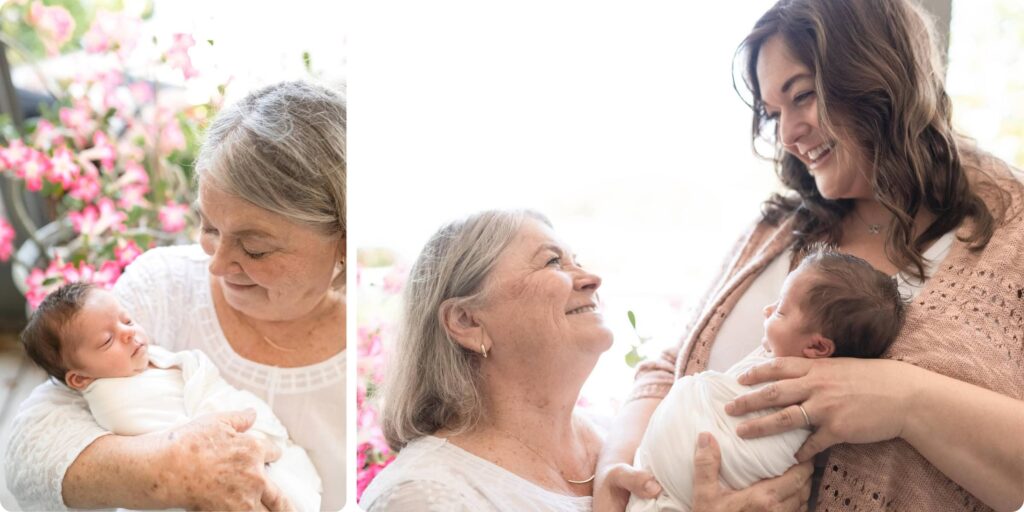 Grandmother cradling newborn baby with pink flowers in background, three generations photographed during newborn session in St. Pete Florida