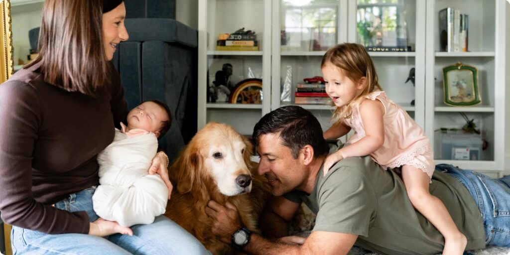 Family with toddler, newborn, and golden retriever photographed together during an in-home lifestyle newborn session in Crescent Heights St. Petersburg