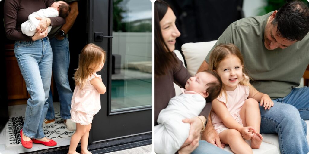 Toddler sibling curiously watching the new baby during a St. Petersburg lifestyle newborn session, with a sweet family moment on the sofa